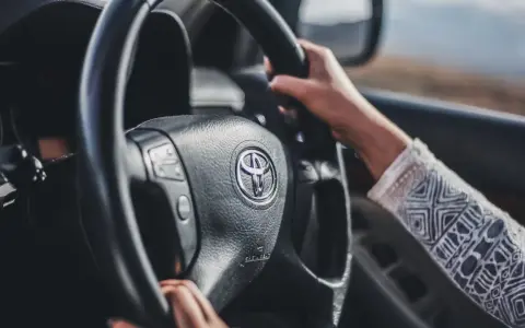 Mani sul volante Toyota, si sente che il volante trema in frenata.