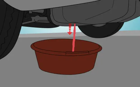 Liquido rosso scende da un'auto in un contenitore. Si sta svuotando il serbatoio auto con tubo.