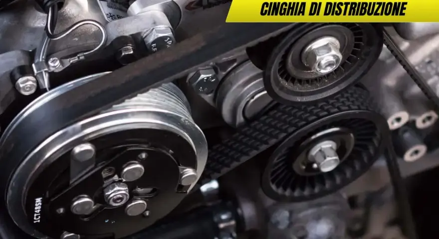 Dettaglio di una cinghia di distribuzione usurata con pulegge e tendicinghia. Sintomi di usura da non ignorare per la salute del motore.